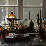 A violin on a workbench while being varnished